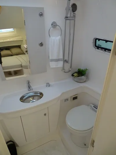  Yacht Photos Pics 2022 Intrepid 407 Panacea bathroom with sink, toilet, and window.