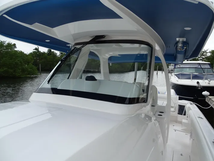  Yacht Photos Pics 2022 Intrepid 407 Panacea boat with sleek design on a calm waterway.