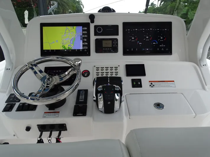  Yacht Photos Pics 2022 Intrepid 407 Panacea helm with navigation screens and controls.