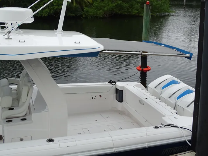  Yacht Photos Pics Intrepid 407 Panacea 2022 boat docked, featuring spacious deck and triple outboard engines.