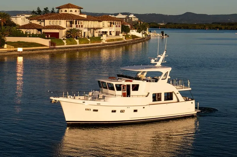  Yacht Photos Pics 2024 Selene 49 yacht cruising near luxury waterfront homes at sunset.