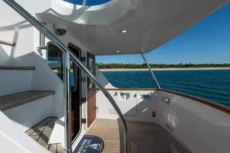  Yacht Photos Pics Luxurious 2024 Selene 49 yacht deck with ocean view and elegant staircase.