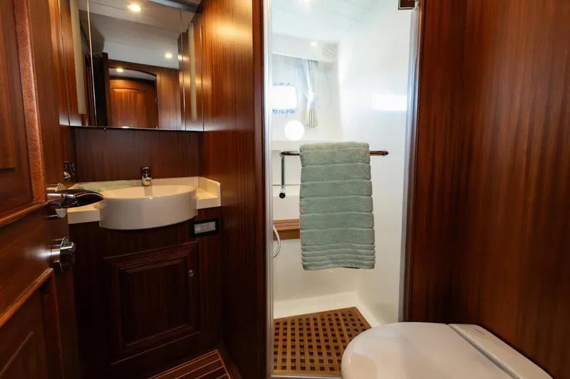  Yacht Photos Pics Luxurious bathroom in 2024 Selene 49 yacht with wooden accents and modern fixtures.