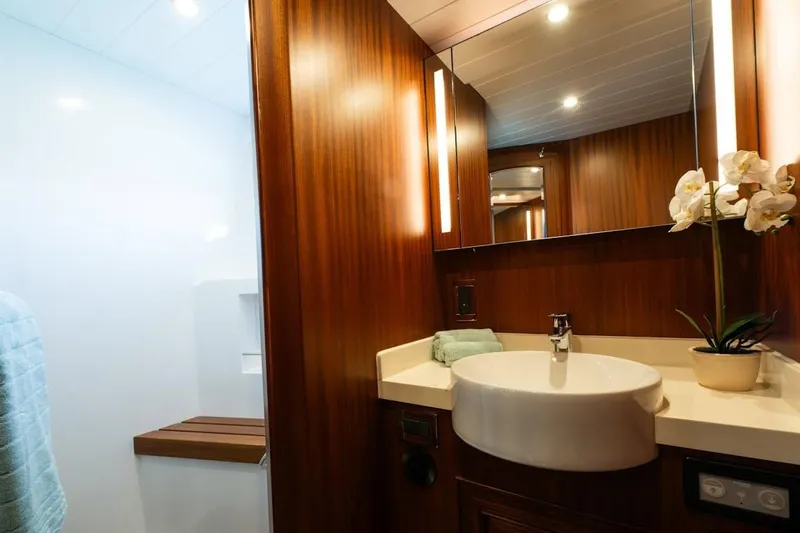  Yacht Photos Pics Luxurious bathroom interior of 2024 Selene 49 yacht with wood paneling and modern fixtures.