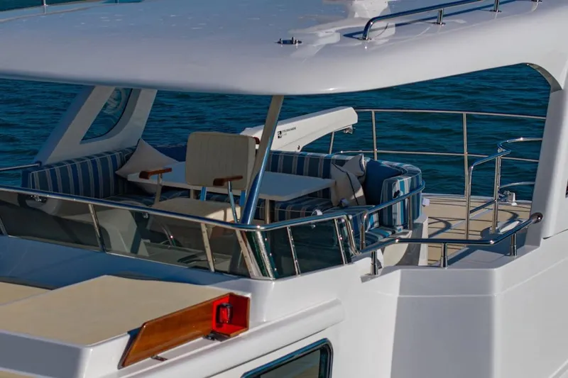  Yacht Photos Pics 2024 Selene 49 yacht with elegant deck seating, cruising on blue waters.