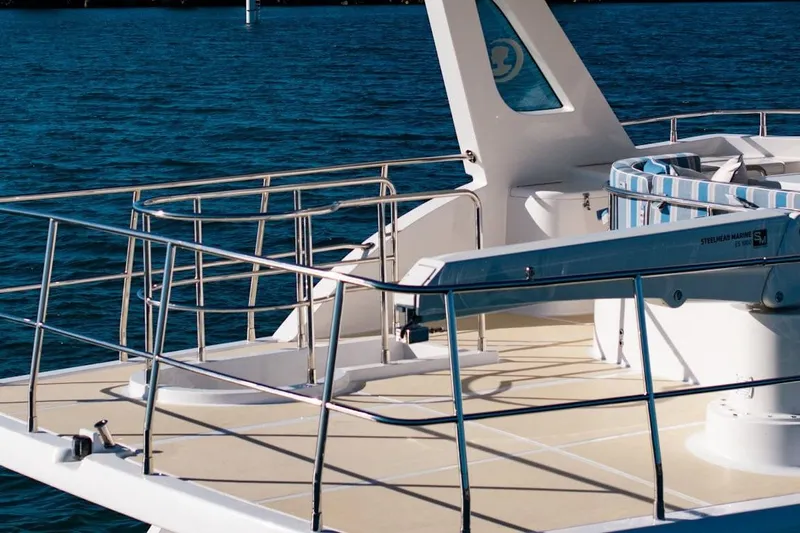  Yacht Photos Pics Luxurious 2024 Selene 49 yacht deck with railing, overlooking serene blue waters.