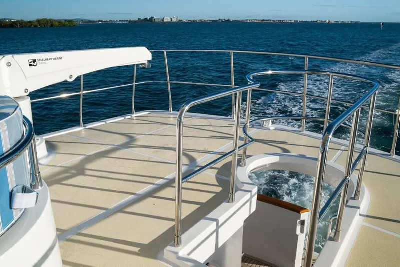  Yacht Photos Pics Luxury yacht deck with railing, ocean view; 2024 Selene 49 model.