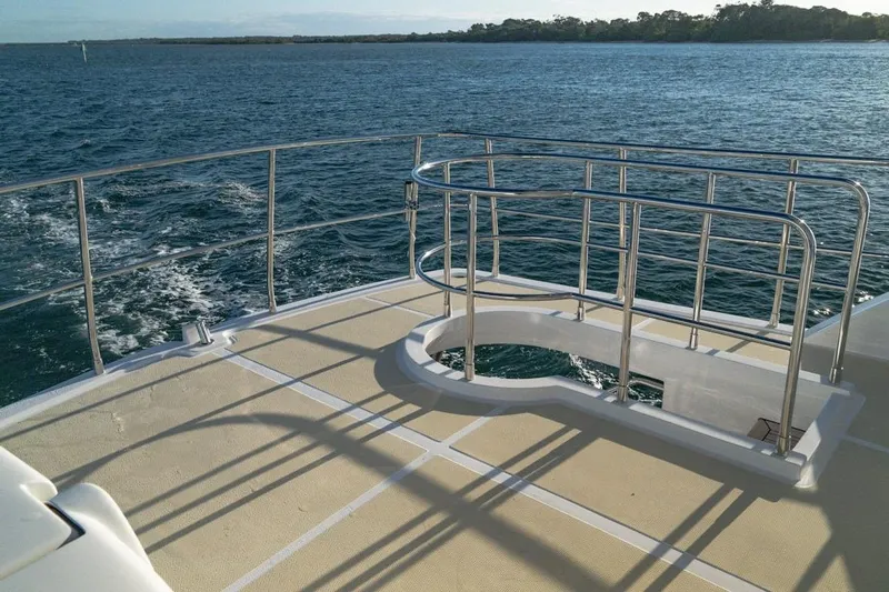 Yacht Photos Pics 2024 Selene 49 yacht deck with stainless steel railings, overlooking calm blue waters.