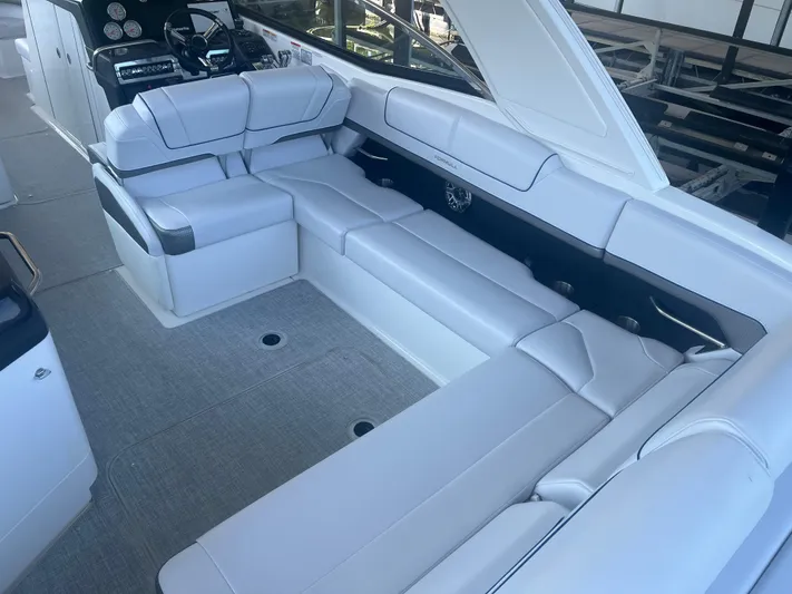  Yacht Photos Pics 2023 Formula 310 Bowrider I/O interior with luxurious white seating and modern dashboard.