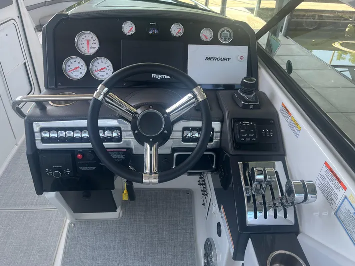  Yacht Photos Pics 2023 Formula 310 Bowrider I/O dashboard with steering wheel and control panel.