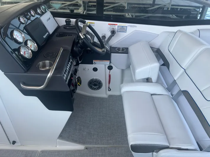  Yacht Photos Pics 2023 Formula 310 Bowrider I/O cockpit with modern controls and white seating.