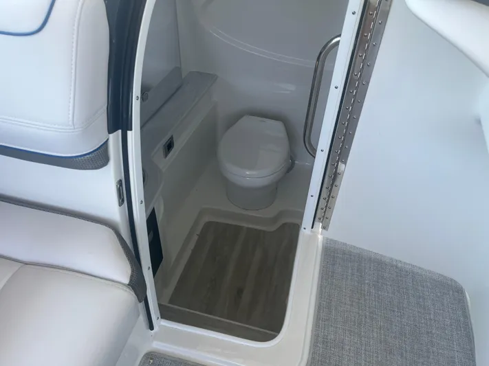  Yacht Photos Pics Interior of 2023 Formula 310 Bowrider I/O boat featuring a compact marine toilet.