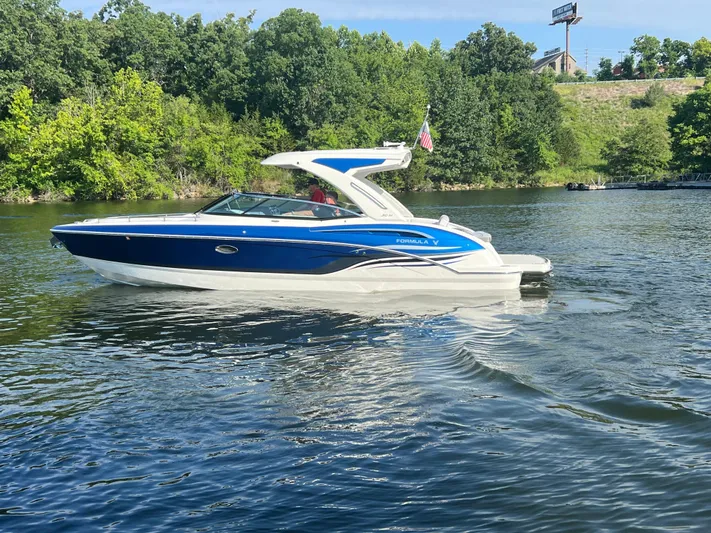  Yacht Photos Pics 2023 Formula 310 Bowrider I/O boat cruising on a scenic lake.