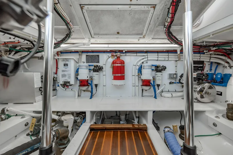 Nuts And Bolts Yacht Photos Pics Engine room of a 1998 Scopinich Custom Express boat with fire extinguisher and equipment.