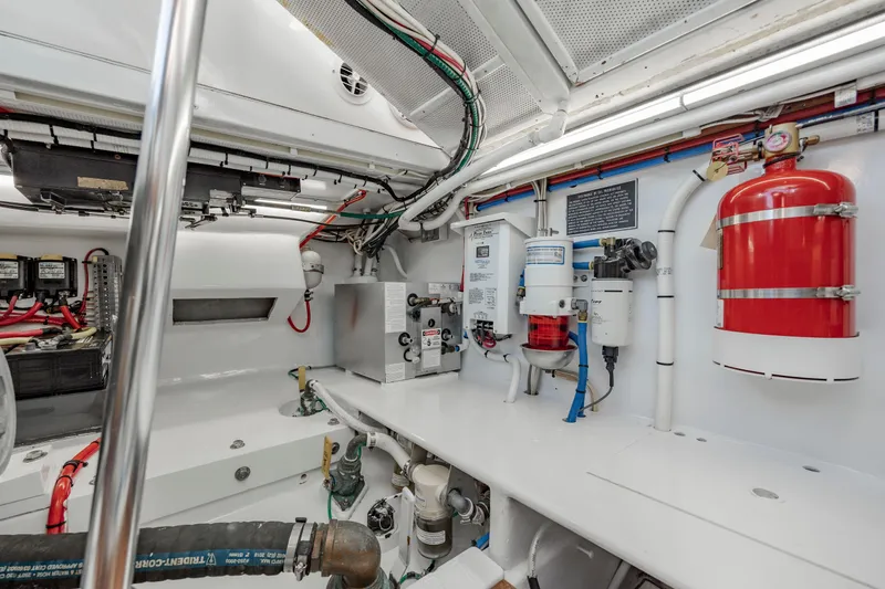 Nuts And Bolts Yacht Photos Pics 1998 Scopinich Custom Express engine room with fire extinguisher and mechanical components.