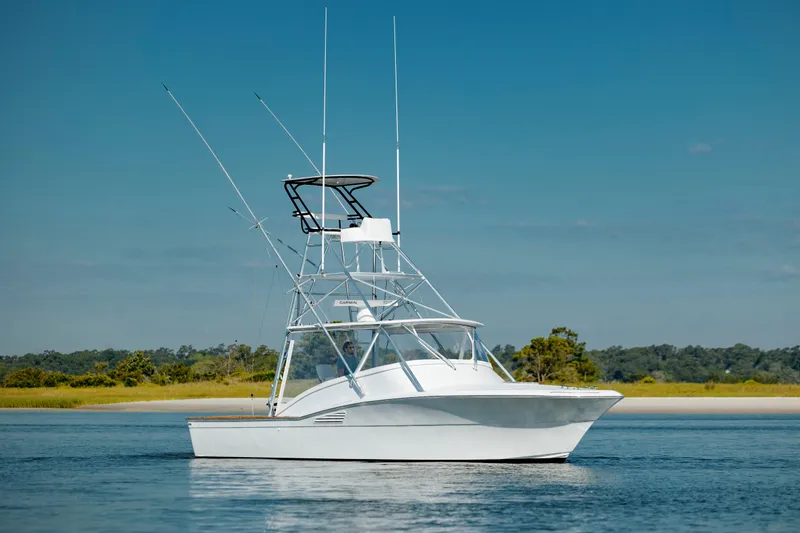 Nuts And Bolts Yacht Photos Pics 1998 Scopinich Custom Express boat on calm water with clear blue sky.