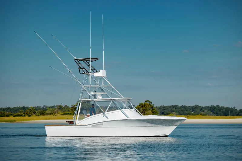 Nuts And Bolts Yacht Photos Pics 1998 Scopinich Custom Express boat on calm water with clear blue sky.