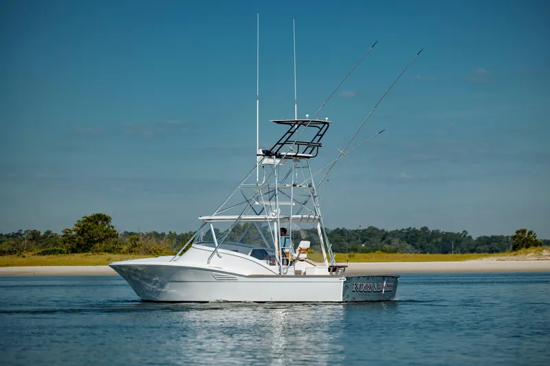 Nuts And Bolts Yacht Photos Pics 1998 Scopinich Custom Express boat on calm water with scenic background.