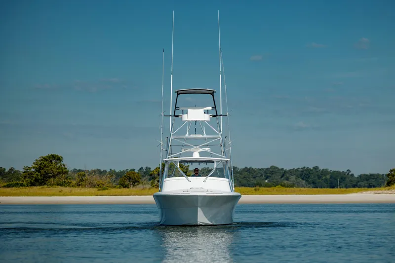 Nuts And Bolts Yacht Photos Pics 1998 Scopinich Custom Express boat on calm water with scenic background.