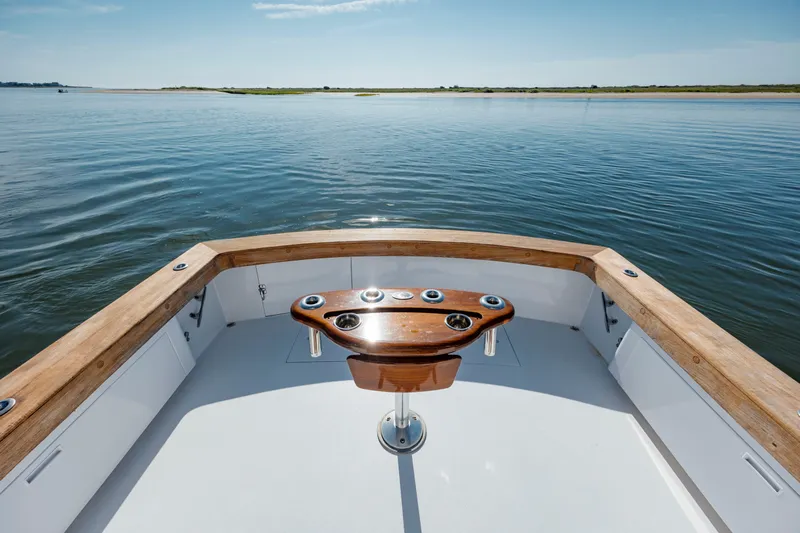 Nuts And Bolts Yacht Photos Pics 1998 Scopinich Custom Express boat on calm water with wooden trim.