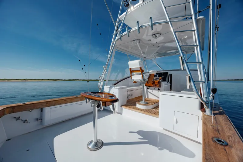 Nuts And Bolts Yacht Photos Pics 1998 Scopinich Custom Express boat with wooden accents on a calm sea.
