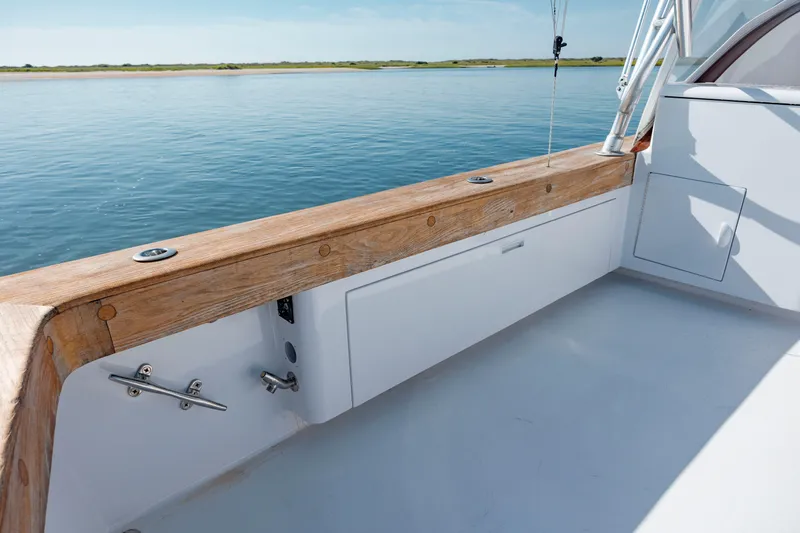 Nuts And Bolts Yacht Photos Pics 1998 Scopinich Custom Express boat deck with wooden rail and ocean view.