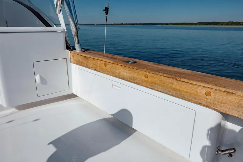 Nuts And Bolts Yacht Photos Pics 1998 Scopinich Custom Express boat deck with wooden railing and storage compartments.