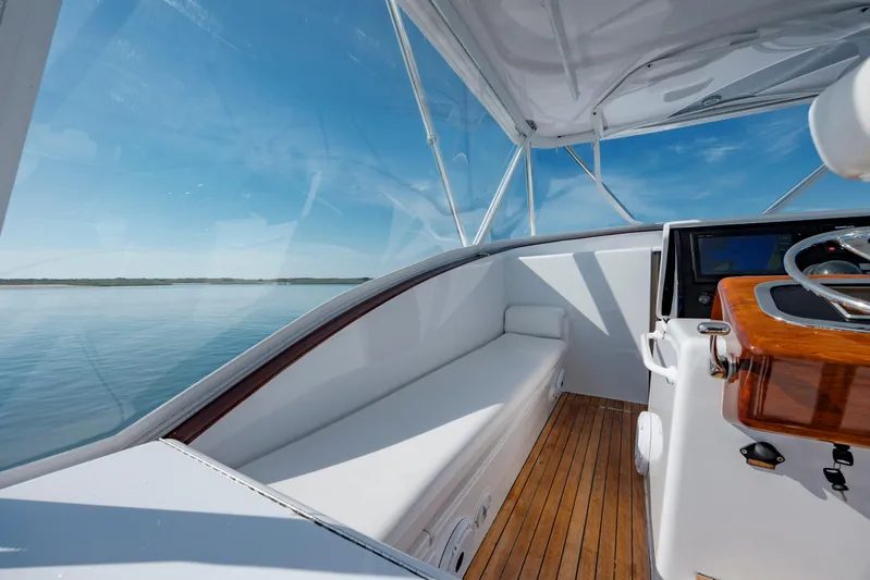 Nuts And Bolts Yacht Photos Pics 1998 Scopinich Custom Express boat interior with wooden deck and white seating.