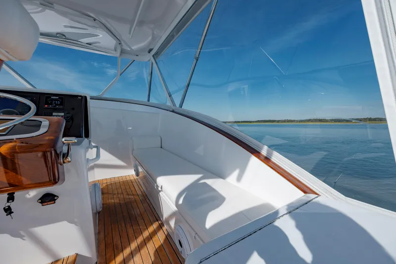 Nuts And Bolts Yacht Photos Pics 1998 Scopinich Custom Express boat interior with wooden deck and white seating.