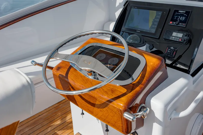 Nuts And Bolts Yacht Photos Pics 1998 Scopinich Custom Express helm with wooden steering wheel and modern navigation instruments.