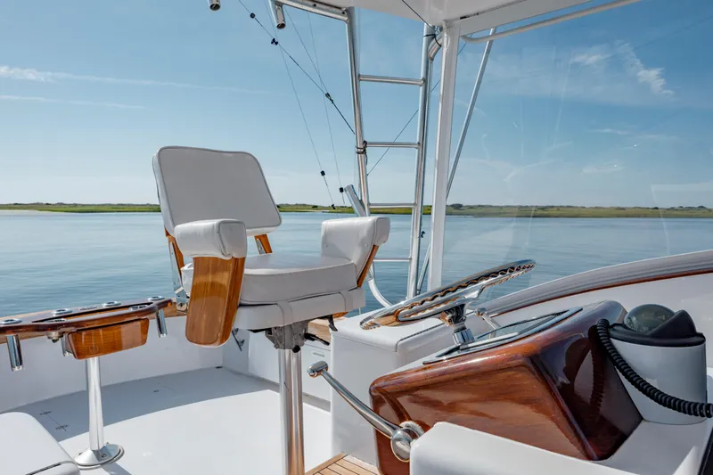 Nuts And Bolts Yacht Photos Pics 1998 Scopinich Custom Express boat helm with captain's chair and scenic water view.