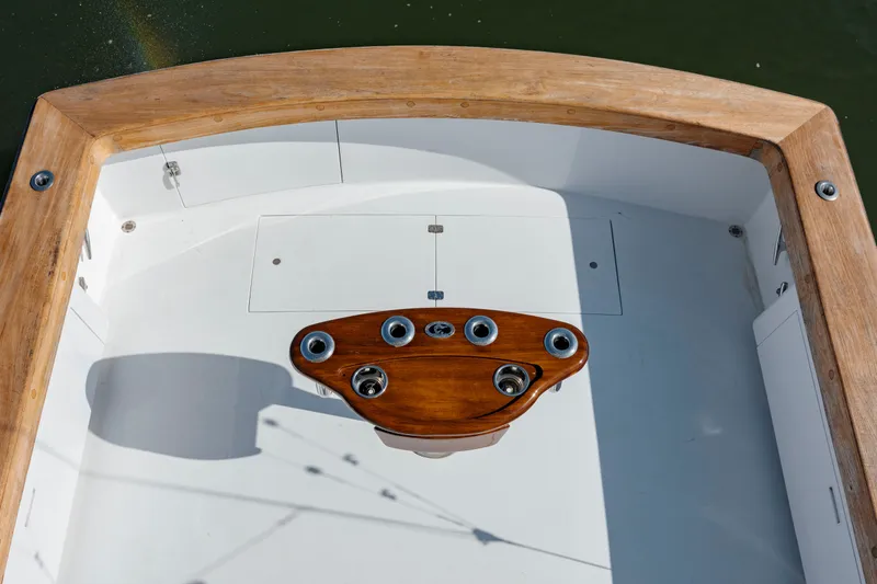 Nuts And Bolts Yacht Photos Pics 1998 Scopinich Custom Express boat deck with wooden trim and rod holders.