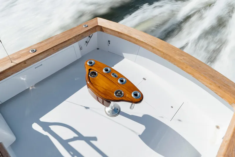 Nuts And Bolts Yacht Photos Pics 1998 Scopinich Custom Express boat deck with wooden trim and fishing rod holders.