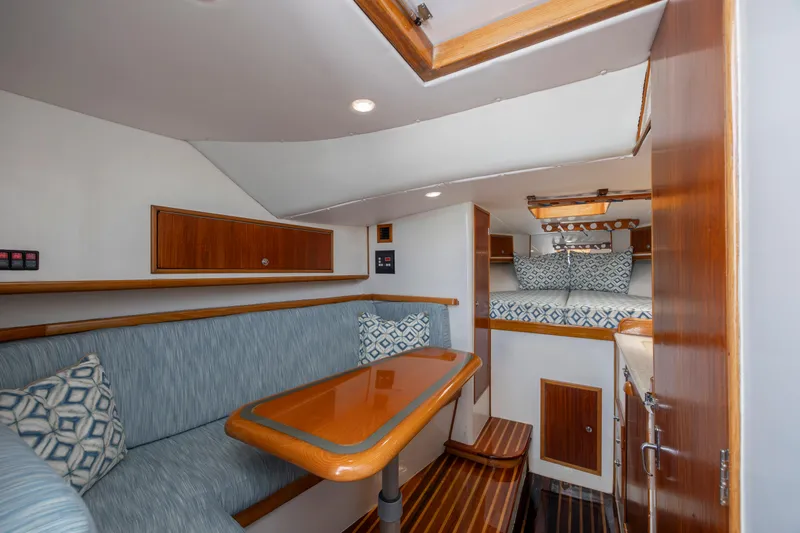 Nuts And Bolts Yacht Photos Pics 1998 Scopinich Custom Express cabin interior with seating, table, and sleeping area.