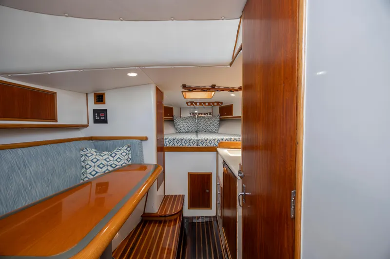 Nuts And Bolts Yacht Photos Pics 1998 Scopinich Custom Express boat interior with wood finishes and seating area.
