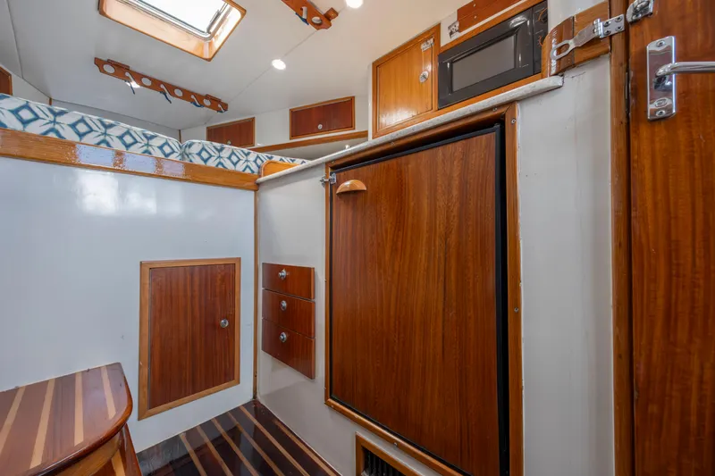 Nuts And Bolts Yacht Photos Pics 1998 Scopinich Custom Express cabin interior with wood paneling and built-in storage.