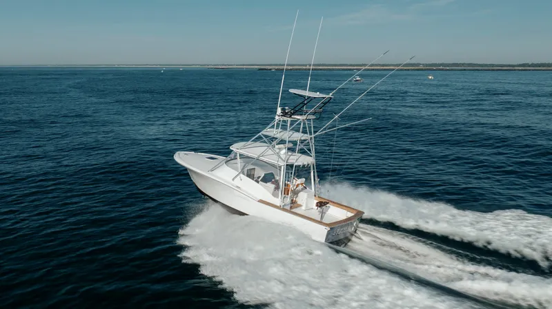 Nuts And Bolts Yacht Photos Pics 1998 Scopinich Custom Express boat cruising on open water.