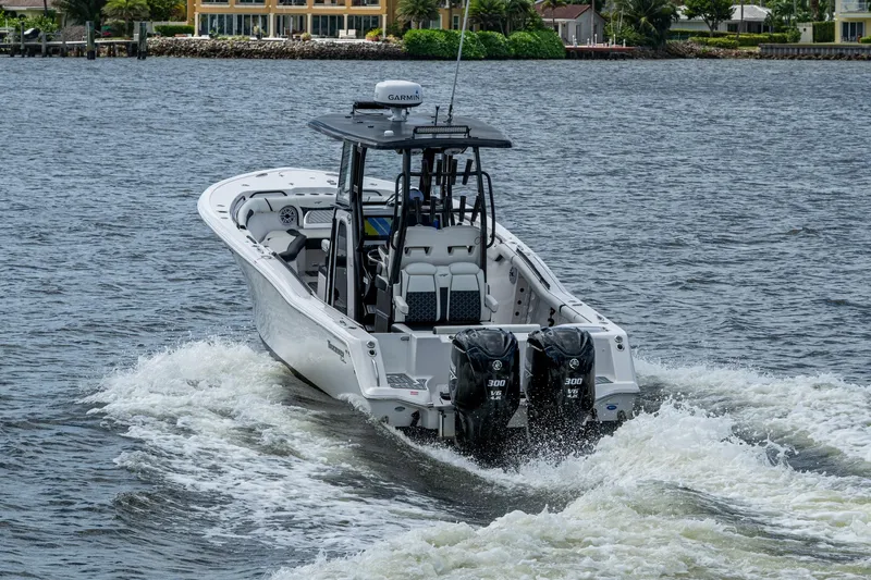 Floating Stones Yacht Photos Pics 2022 Tidewater 292 CC Adventure boat cruising on water with dual engines.