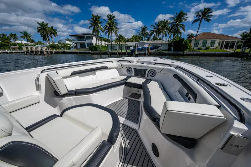Floating Stones Yacht Photos Pics 2022 Tidewater 292 CC Adventure boat interior with luxurious seating and waterfront view.