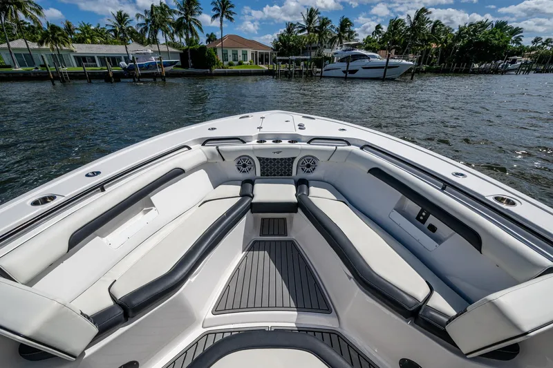 Floating Stones Yacht Photos Pics 2022 Tidewater 292 CC Adventure boat interior with luxurious seating and waterfront view.