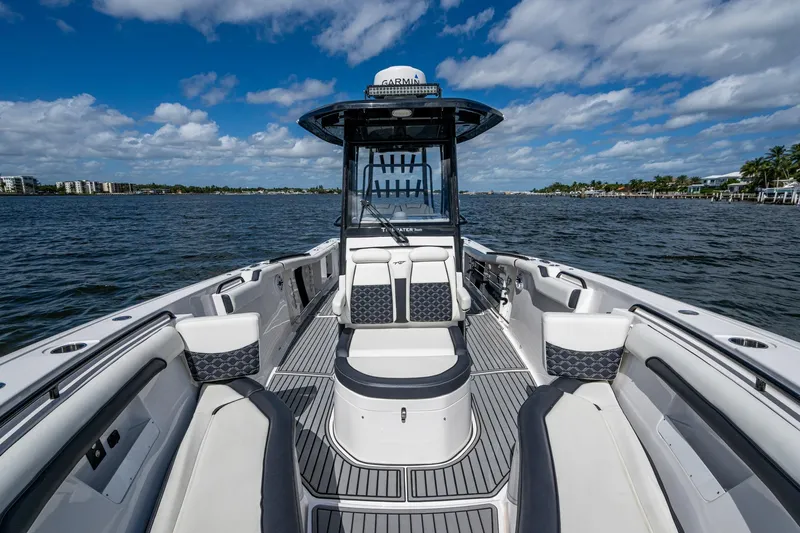 Floating Stones Yacht Photos Pics 2022 Tidewater 292 CC Adventure boat on open water, featuring spacious seating and modern design.