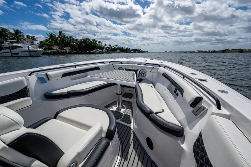 Floating Stones Yacht Photos Pics 2022 Tidewater 292 CC Adventure boat interior with seating and table on a sunny day.