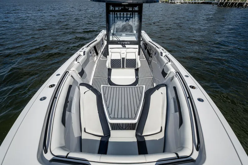 Floating Stones Yacht Photos Pics 2022 Tidewater 292 CC Adventure boat with spacious seating on calm water.