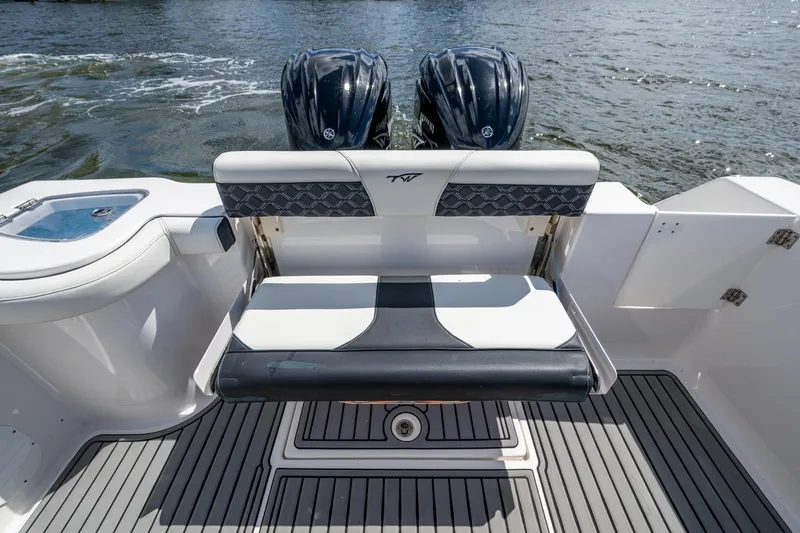 Floating Stones Yacht Photos Pics 2022 Tidewater 292 CC Adventure boat with dual engines and sleek seating on the water.