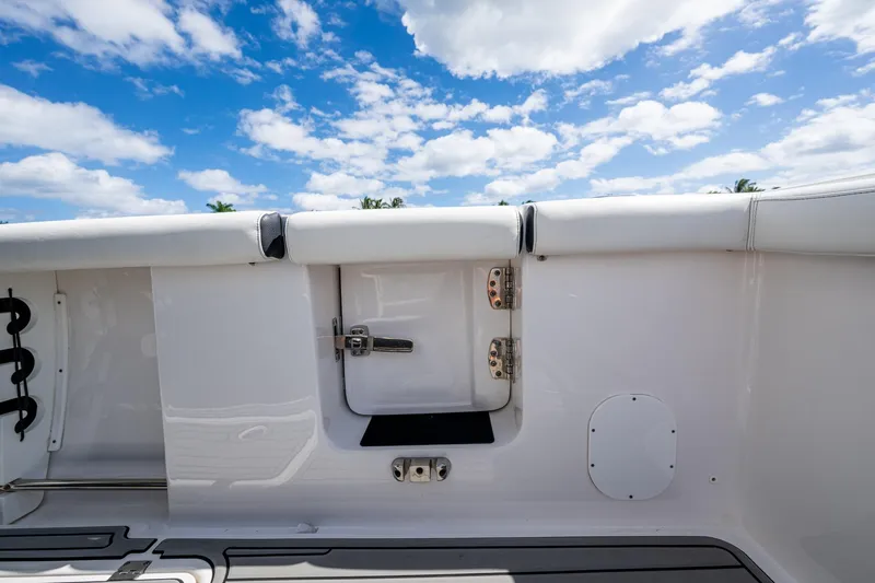 Floating Stones Yacht Photos Pics 2022 Tidewater 292 CC Adventure boat interior with white seating and blue sky background.