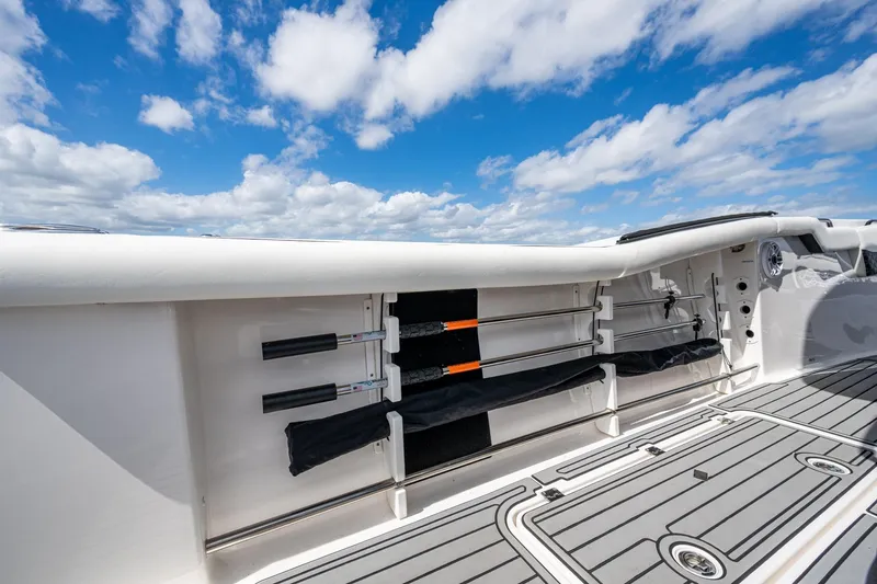 Floating Stones Yacht Photos Pics 2022 Tidewater 292 CC Adventure boat deck with rod holders under a blue sky.