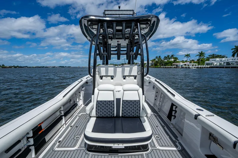 Floating Stones Yacht Photos Pics 2022 Tidewater 292 CC Adventure boat on water, featuring sleek seating and modern design.