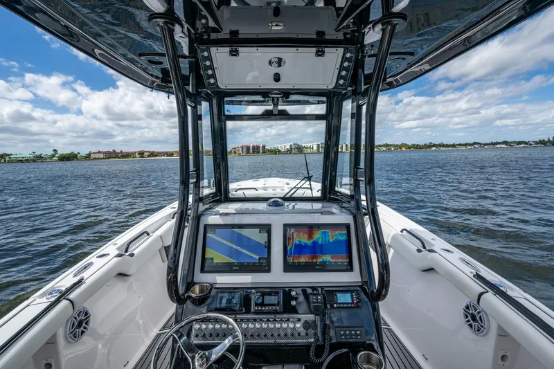 Floating Stones Yacht Photos Pics Cockpit view of 2022 Tidewater 292 CC Adventure boat with navigation screens.