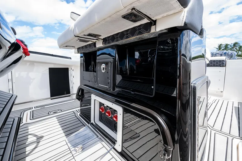 Floating Stones Yacht Photos Pics 2022 Tidewater 292 CC Adventure boat interior with sleek black console and cushioned seating.