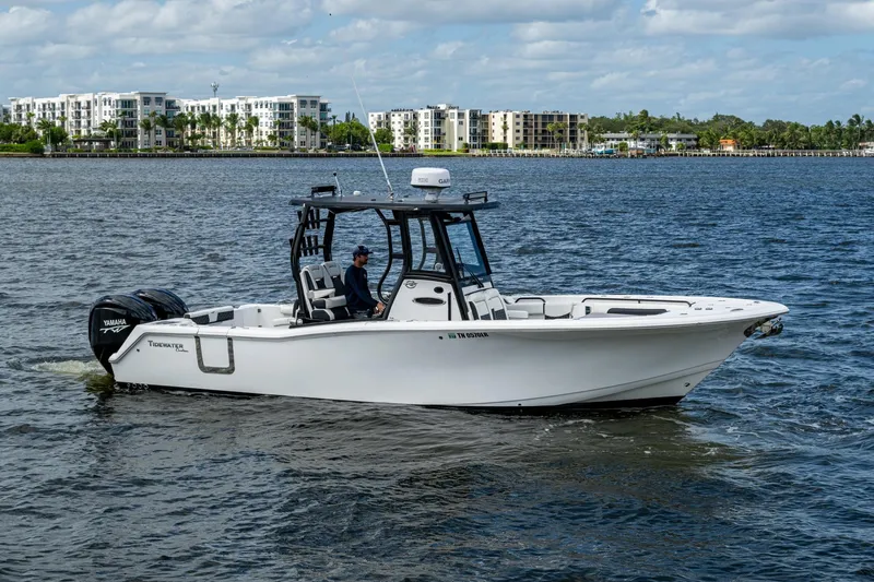 Floating Stones Yacht Photos Pics 2022 Tidewater 292 CC Adventure boat cruising on a scenic waterway.